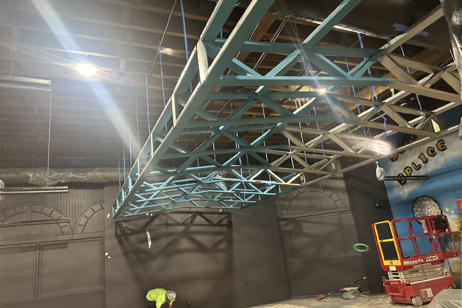 a large room with a metal frame and a blue ceiling