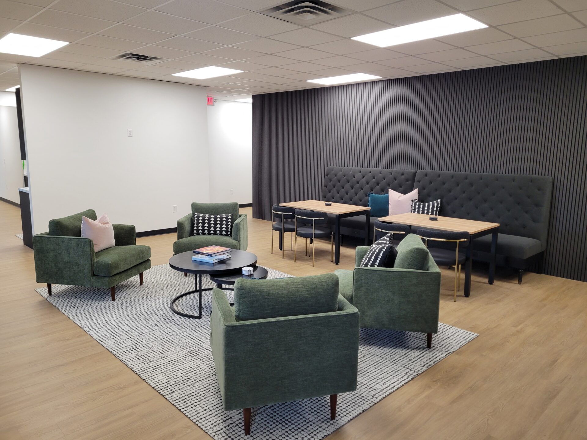 The image shows a modern office lounge or waiting area